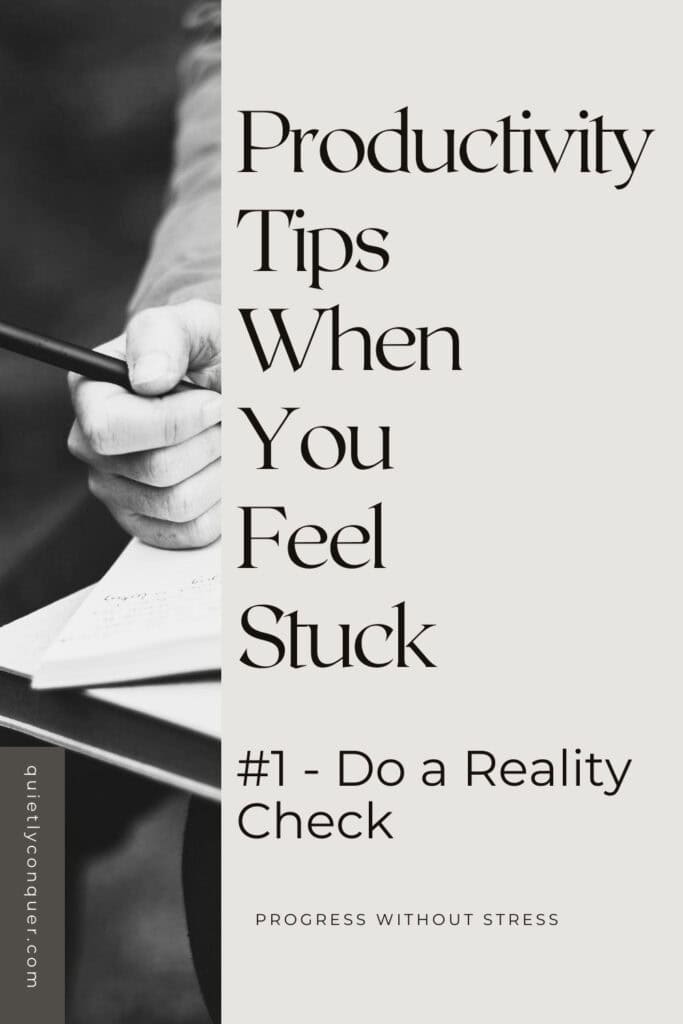 Image shows someone holding a pen over a notebook. Text reads Tip When You feel Stuck - Do a reality check