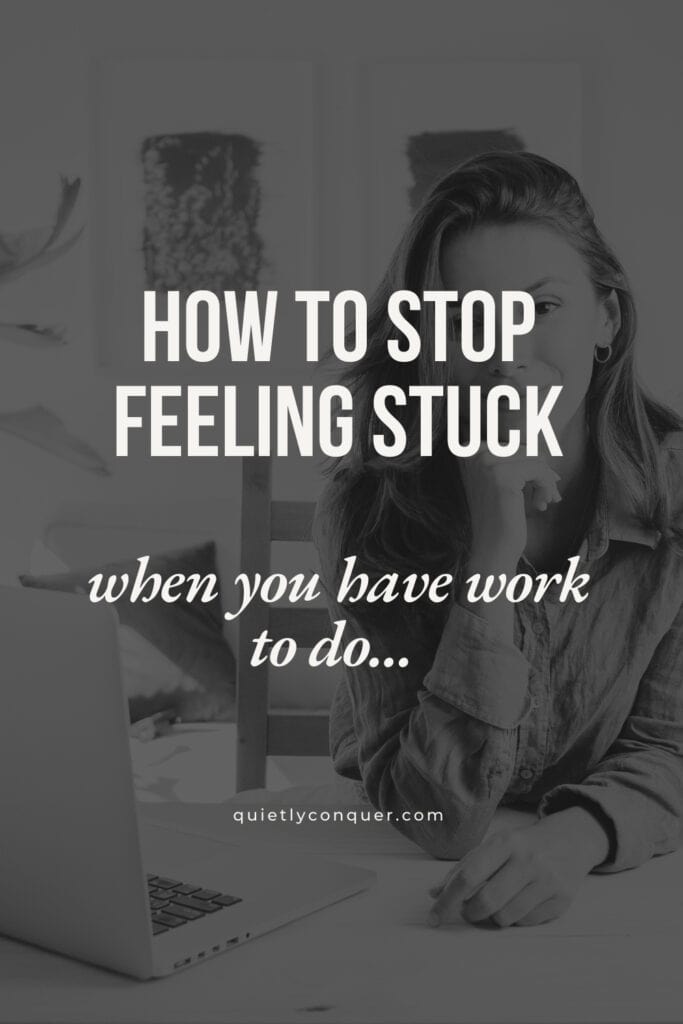How to stop feeling stuck - when you have work to do. Woman sat at desk with laptop open