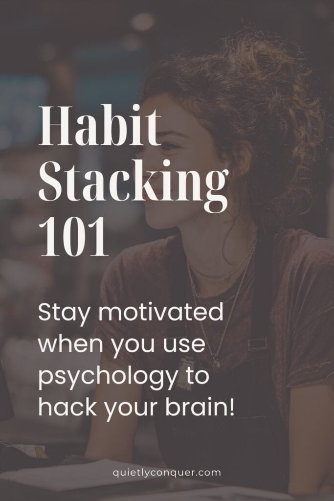 Habit Stacking 101: How to use psychology to hack your brain. Image of a woman sat at her desk smiling