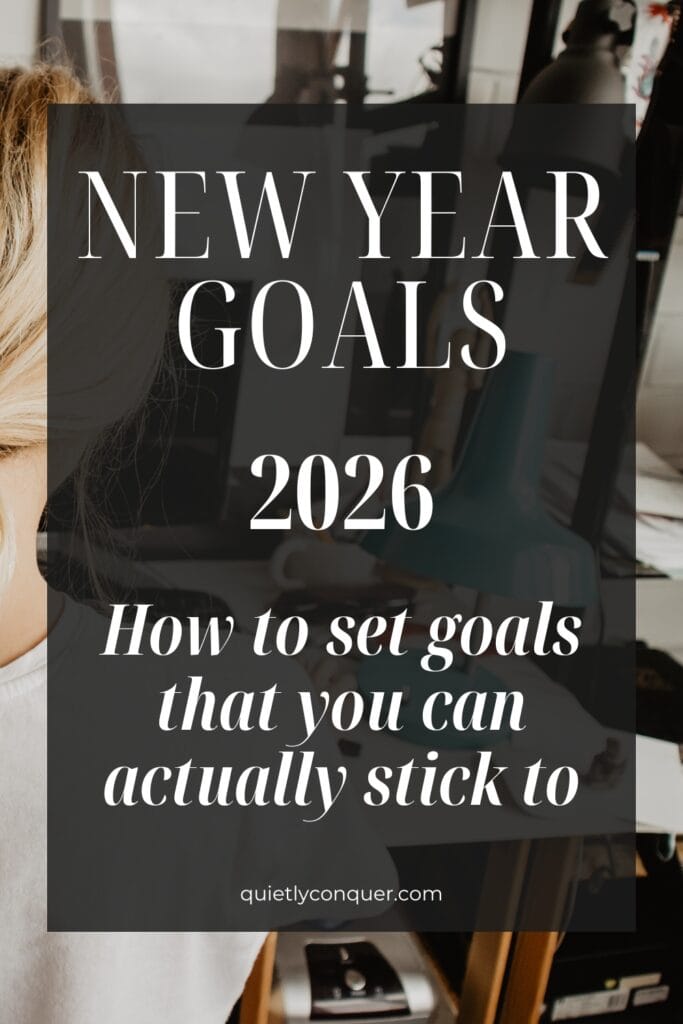 Woman sat at desk working. Text Reads - "New Year Goals 2026: How to Set Goals That You Can Actually Stick to"