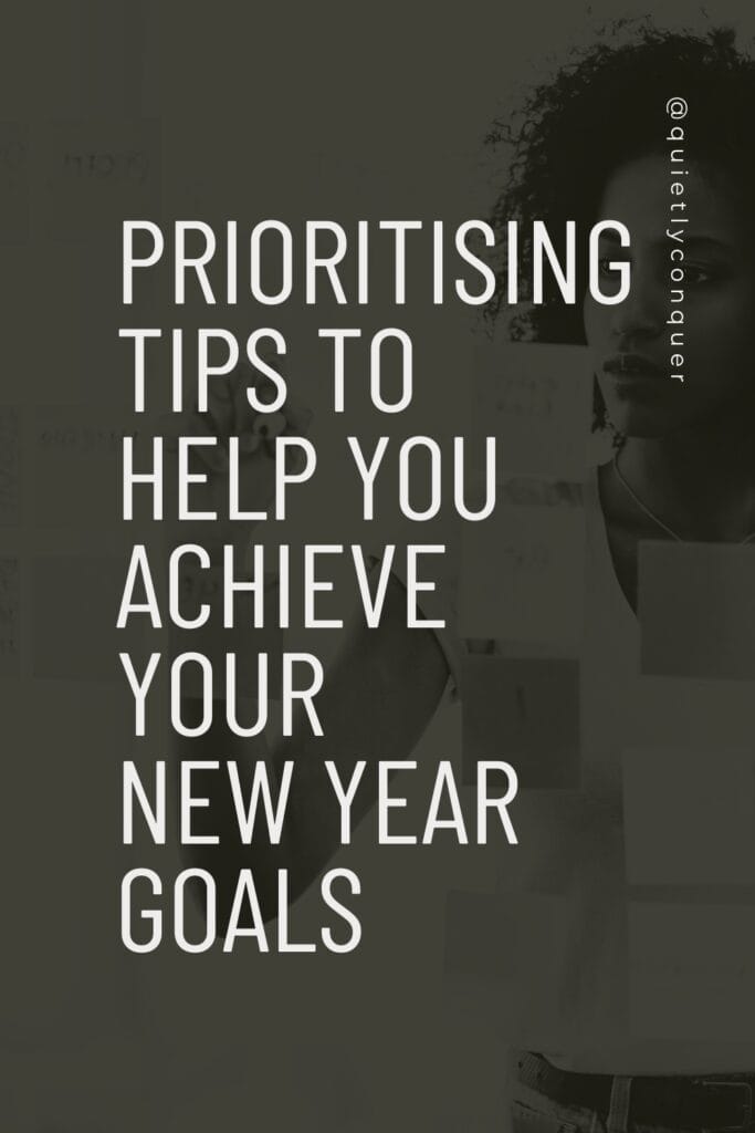 Woman working with post it notes. Text reads "Prioritising tips to help you achieve your new year goals"