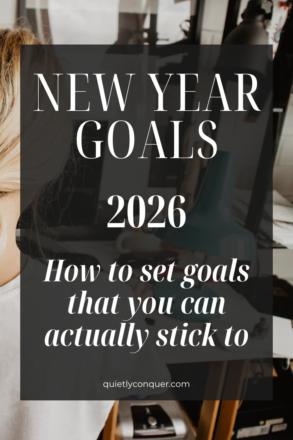 Woman sat at desk working. Text Reads - "New Year Goals 2026: How to Set Goals That You Can Actually Stick to"