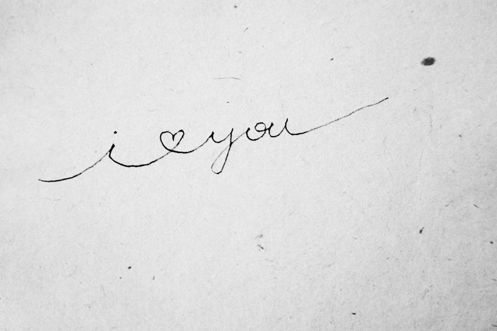 Close-up of 'I love you' handwritten in cursive on textured paper.