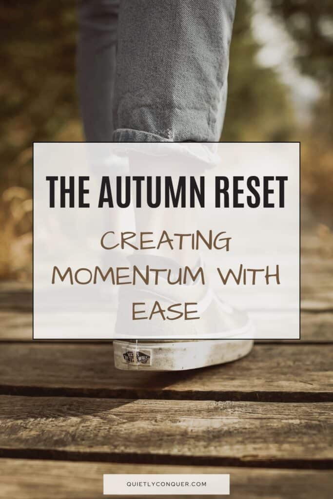 Lower leg in trainers walking on wooden path. Text reads "The Autumn Reset: Creating Momentum With Ease"